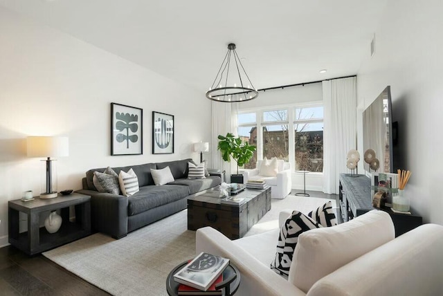 living room with hardwood / wood-style floors and a chandelier