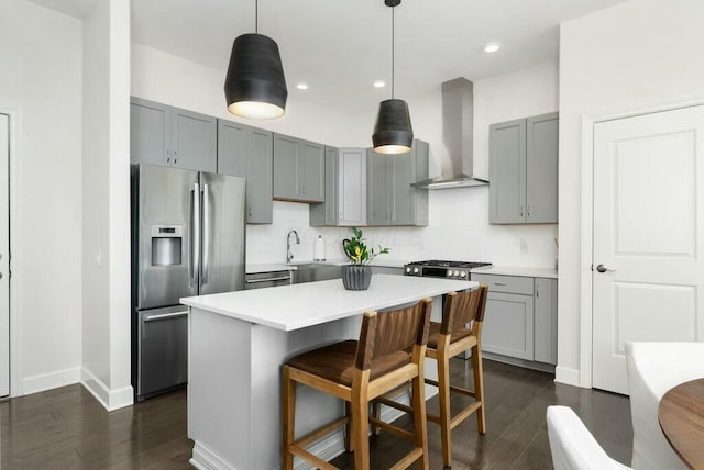 kitchen with pendant lighting, a center island, stainless steel refrigerator with ice dispenser, decorative backsplash, and wall chimney exhaust hood