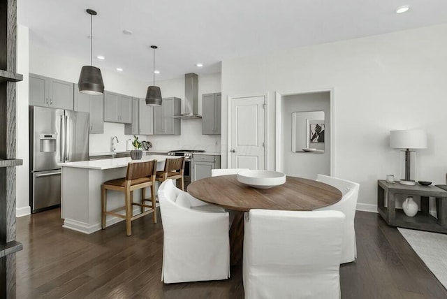 dining room featuring sink and dark hardwood / wood-style floors