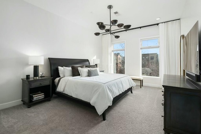 bedroom with a chandelier and carpet floors