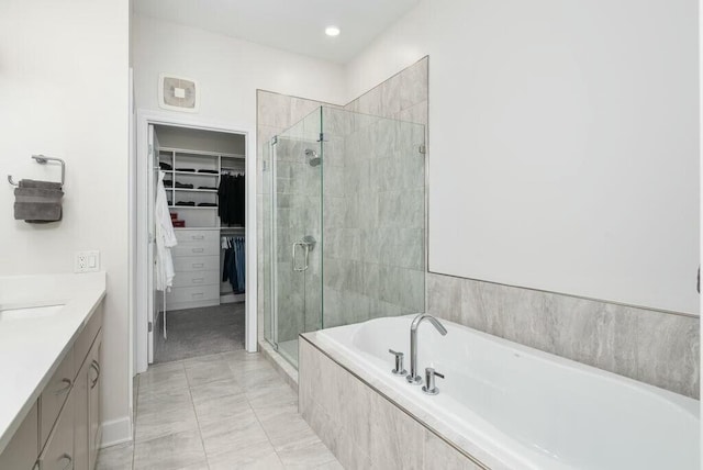 bathroom featuring vanity and separate shower and tub