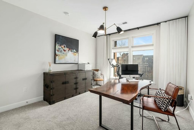 office area featuring a notable chandelier and light colored carpet