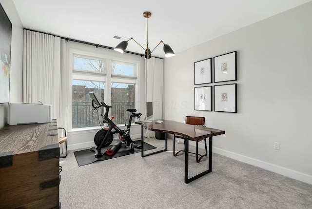 office with a chandelier and carpet flooring