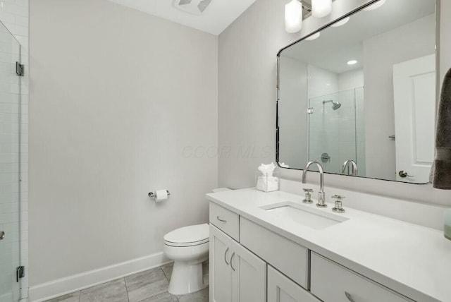 bathroom with tile patterned flooring, vanity, walk in shower, and toilet