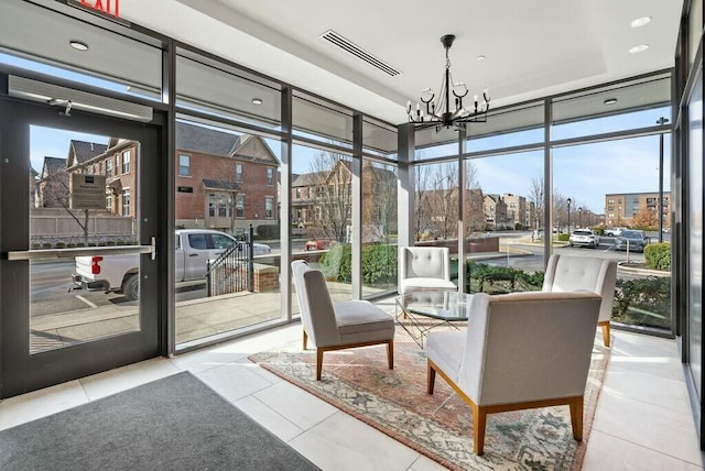 sunroom with a chandelier