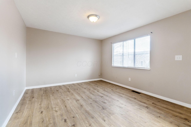 unfurnished room with light hardwood / wood-style flooring