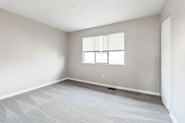 unfurnished room with carpet flooring