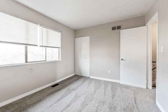 unfurnished bedroom with carpet flooring and a closet