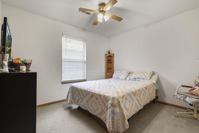 bedroom featuring light carpet and ceiling fan