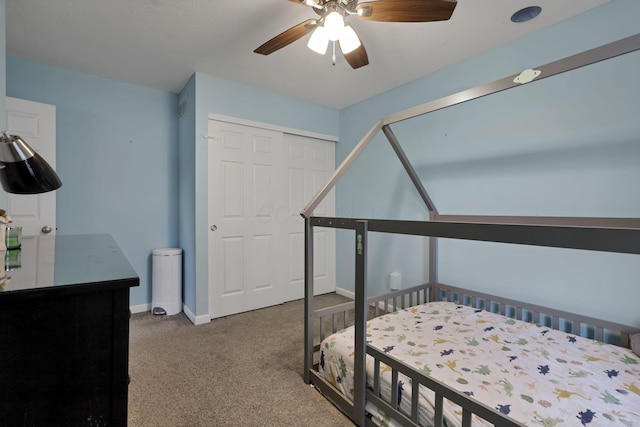 carpeted bedroom featuring ceiling fan and a closet