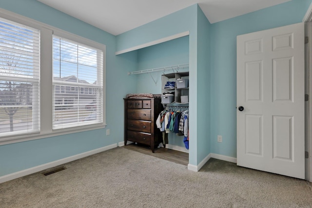 bedroom with light colored carpet and a closet