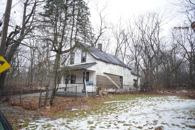 view of snow covered exterior featuring a porch