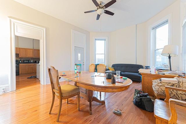 dining space with ceiling fan, a wealth of natural light, and light wood-type flooring