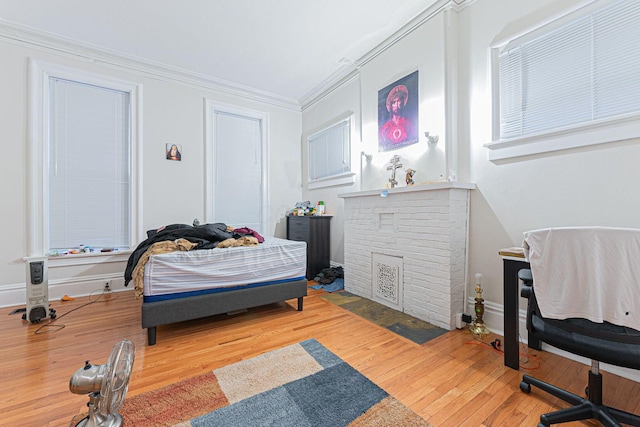 bedroom with crown molding and wood-type flooring