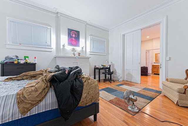 bedroom featuring hardwood / wood-style flooring and ornamental molding