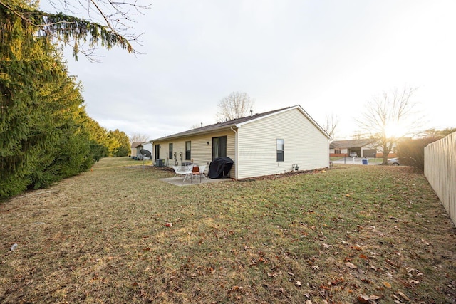 back of house featuring a yard, a patio, and central air condition unit