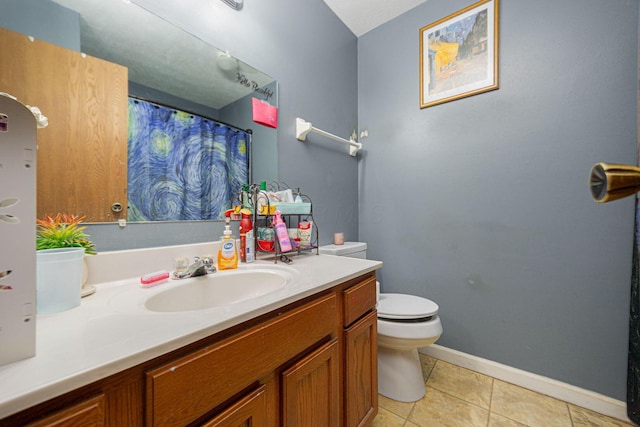 bathroom with vanity, tile patterned floors, and toilet