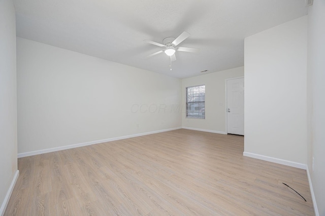 spare room with ceiling fan and light wood-type flooring