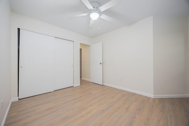 unfurnished bedroom with light hardwood / wood-style flooring, a closet, and ceiling fan