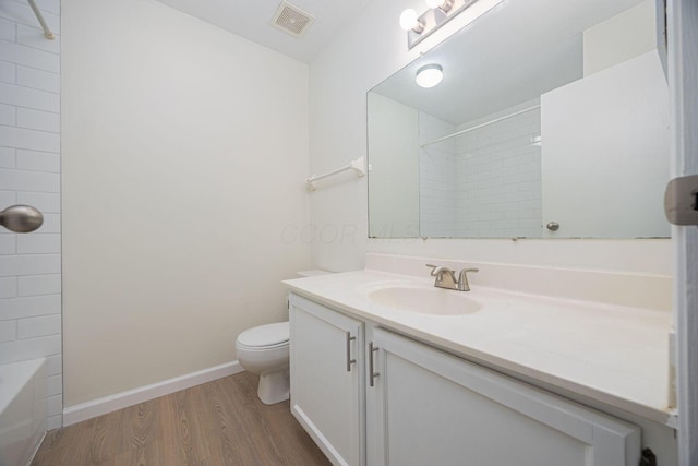 full bathroom with bathtub / shower combination, vanity, toilet, and hardwood / wood-style floors