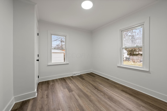 unfurnished room with crown molding and wood-type flooring