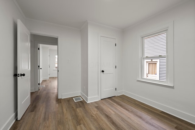 interior space with wood-type flooring and ornamental molding