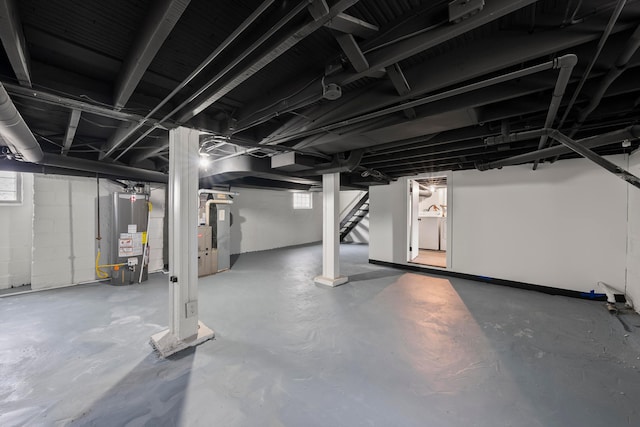 basement featuring gas water heater and plenty of natural light