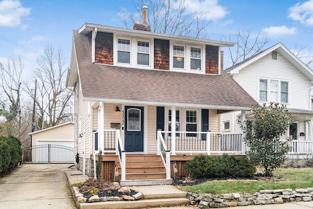 front of property with a garage, an outdoor structure, and covered porch