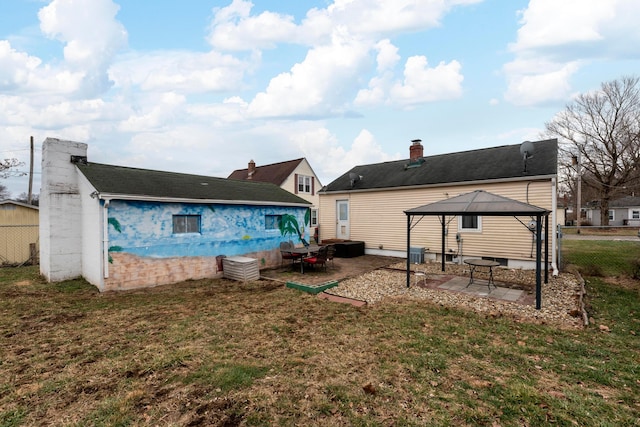 back of property with a gazebo, a yard, and a patio