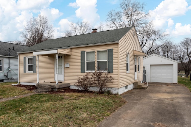 view of front of home with an outbuilding, a garage, and a front yard