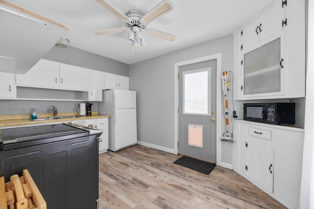 kitchen with sink, electric range oven, light wood-type flooring, white refrigerator, and white cabinets