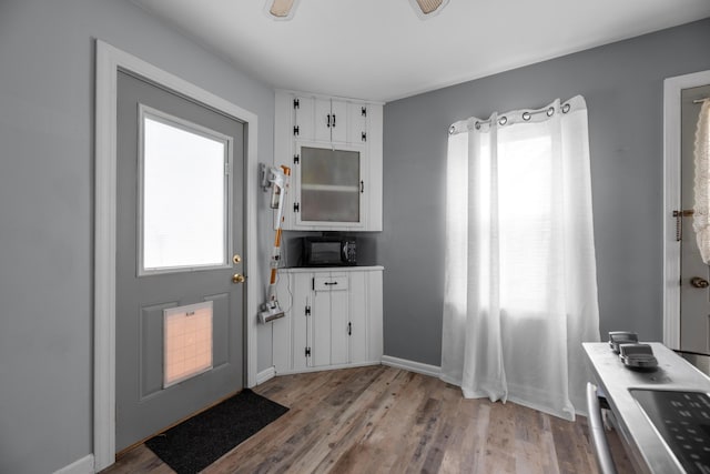 kitchen featuring white cabinetry and light hardwood / wood-style floors