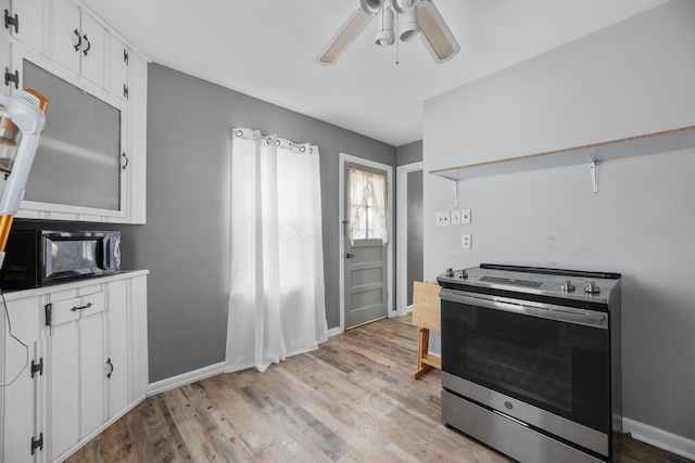 kitchen featuring ceiling fan, stainless steel electric stove, light hardwood / wood-style floors, and white cabinets