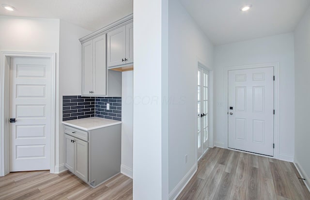 interior space featuring recessed lighting, light wood finished floors, and baseboards