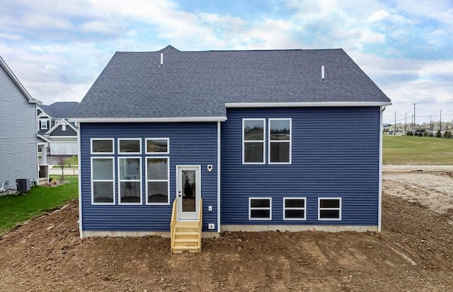 back of house with entry steps and a shingled roof