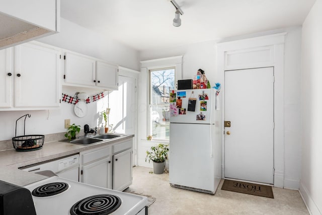 kitchen with white cabinetry, white appliances, rail lighting, and sink