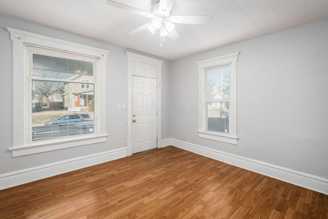 spare room with hardwood / wood-style flooring and ceiling fan