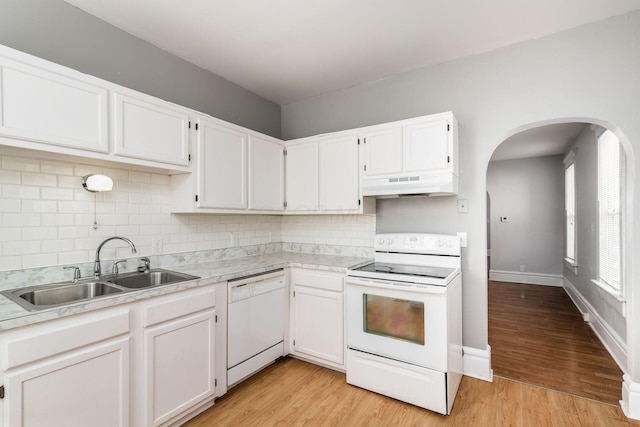 kitchen featuring sink, white cabinets, white appliances, and light hardwood / wood-style floors