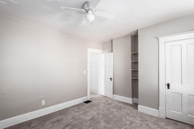 unfurnished bedroom featuring light colored carpet and ceiling fan