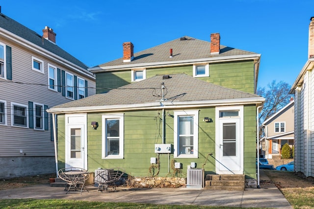 rear view of property featuring central AC unit