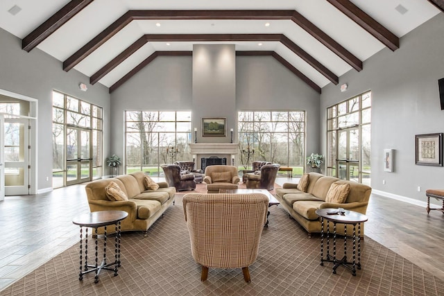 living room with beamed ceiling and high vaulted ceiling