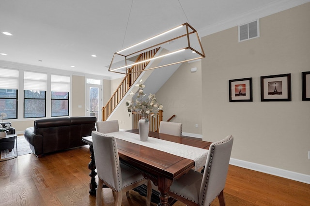 dining room with crown molding and dark hardwood / wood-style flooring