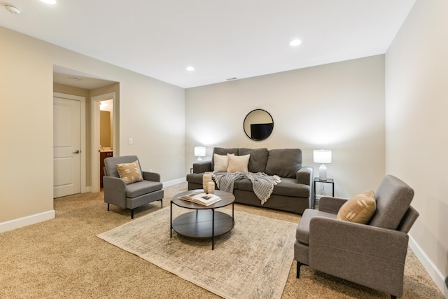 living area featuring baseboards, recessed lighting, and light carpet