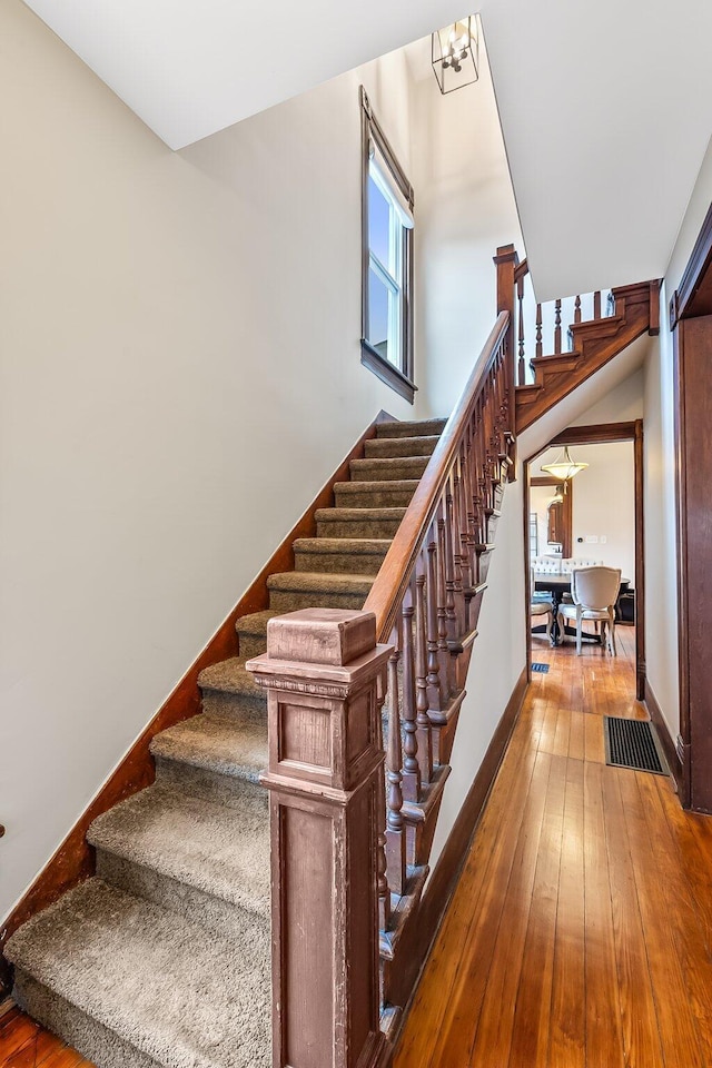 stairway featuring hardwood / wood-style flooring