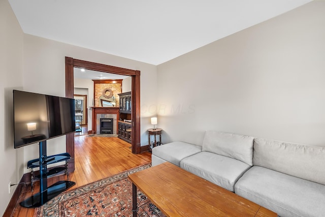 living room featuring hardwood / wood-style flooring and a fireplace