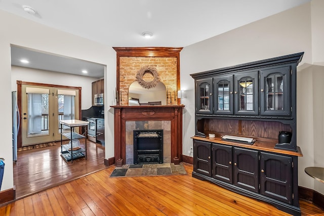 living room with wood-type flooring and a fireplace