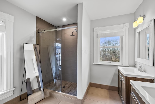 bathroom featuring vanity, a shower with door, and tile patterned floors