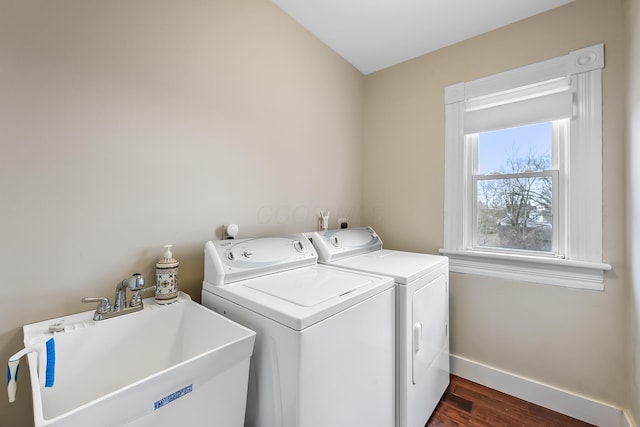 washroom featuring washing machine and clothes dryer, dark hardwood / wood-style floors, and sink