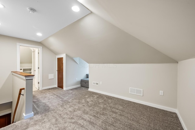 additional living space with lofted ceiling and carpet flooring