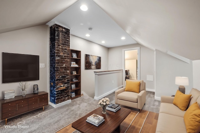 living room with vaulted ceiling and light hardwood / wood-style floors